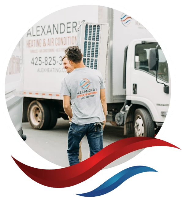 2 Alexander’s Heating & Air employees carrying an HVAC unit from their branded truck